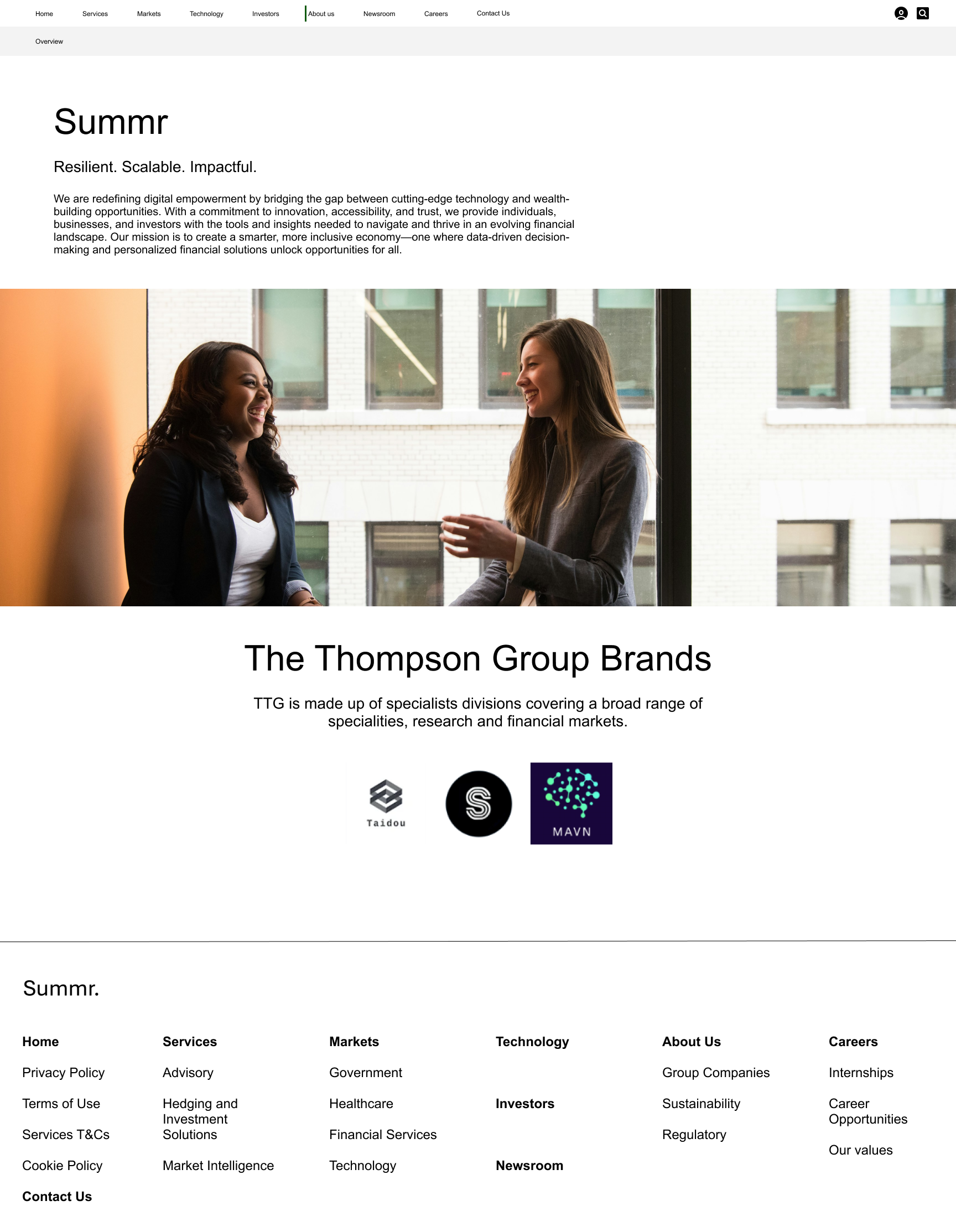 Two professional women having a conversation in an office setting